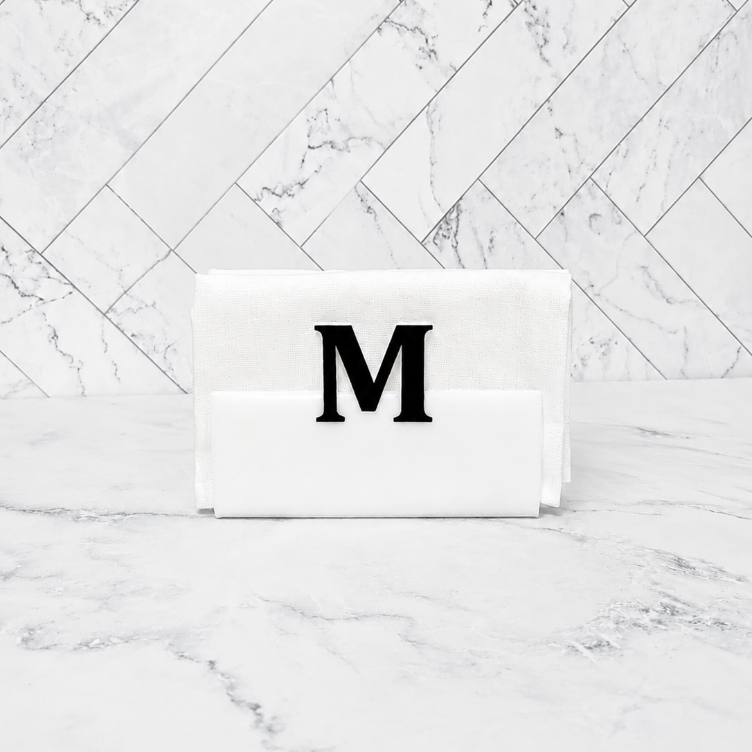 Rectangular whitenapkin holder with a black letter 'M' on a marble background - Zstander