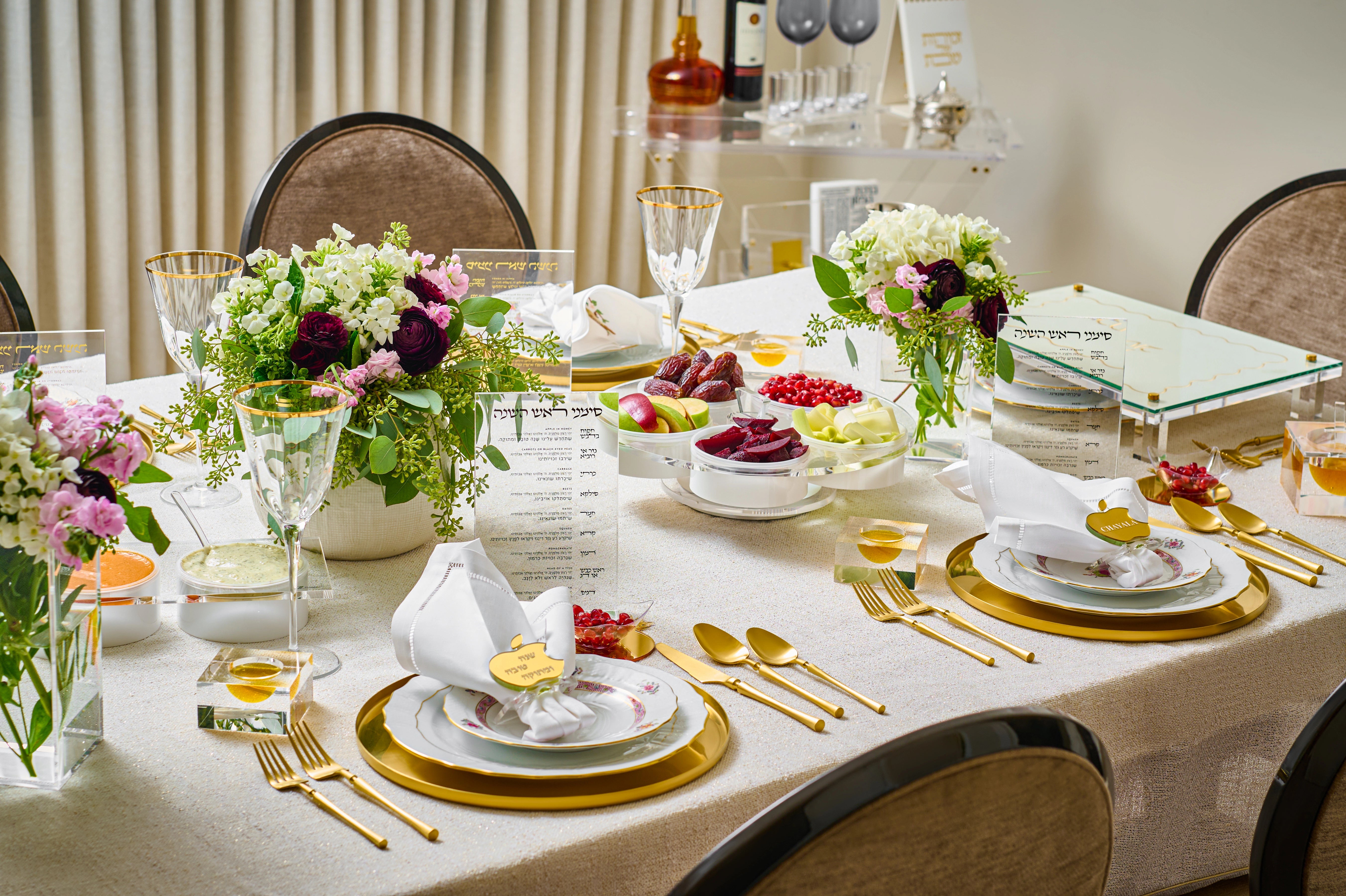 Elegant Rosh Hashana dining table set with flowers, cutlery, and place settings in a formal setting - Zstander