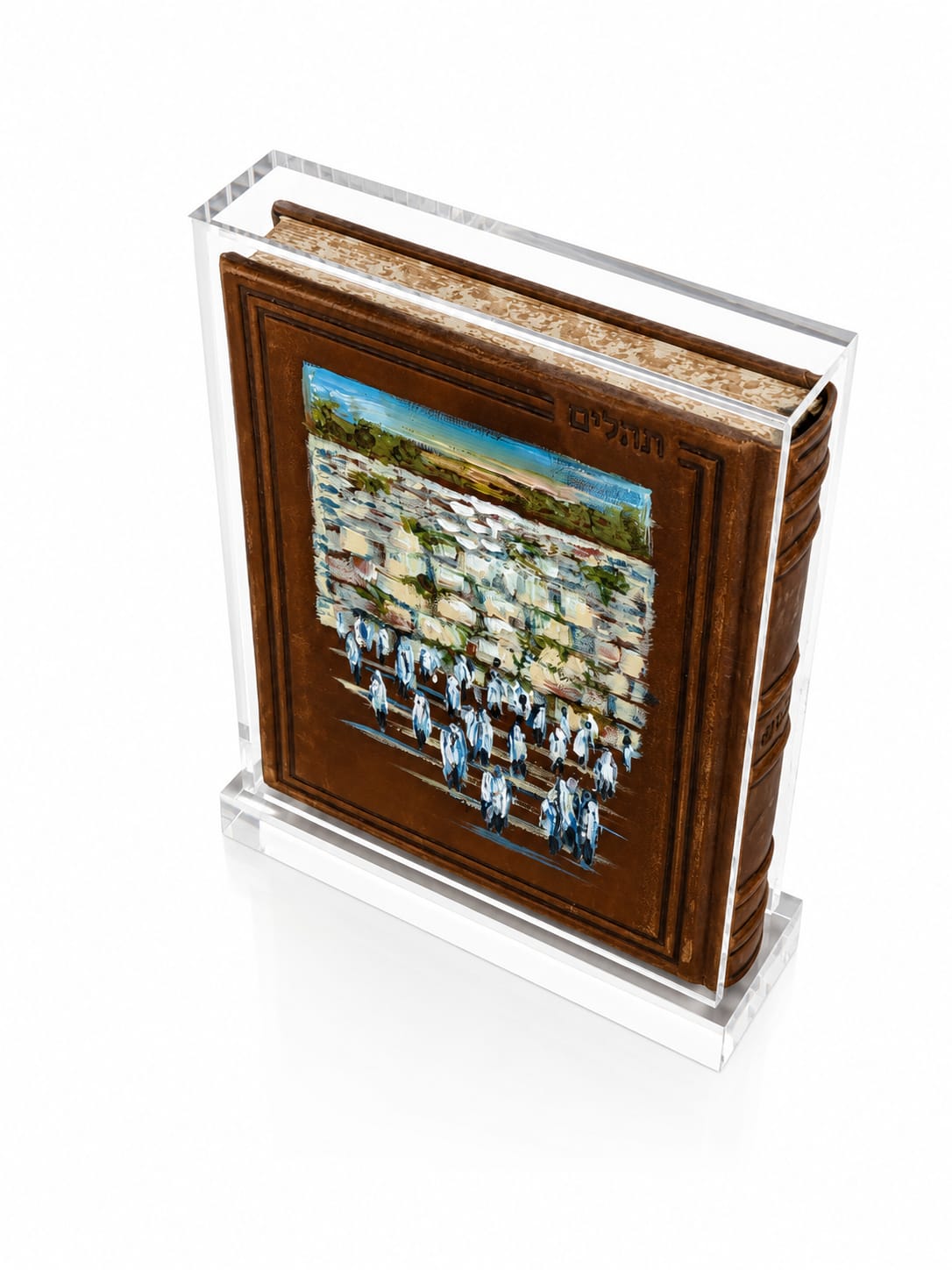 A large tehillim with a brown leather cover and a colorful illustrated front panel, displayed inside a clear acrylic stand on a white background - Zstander
