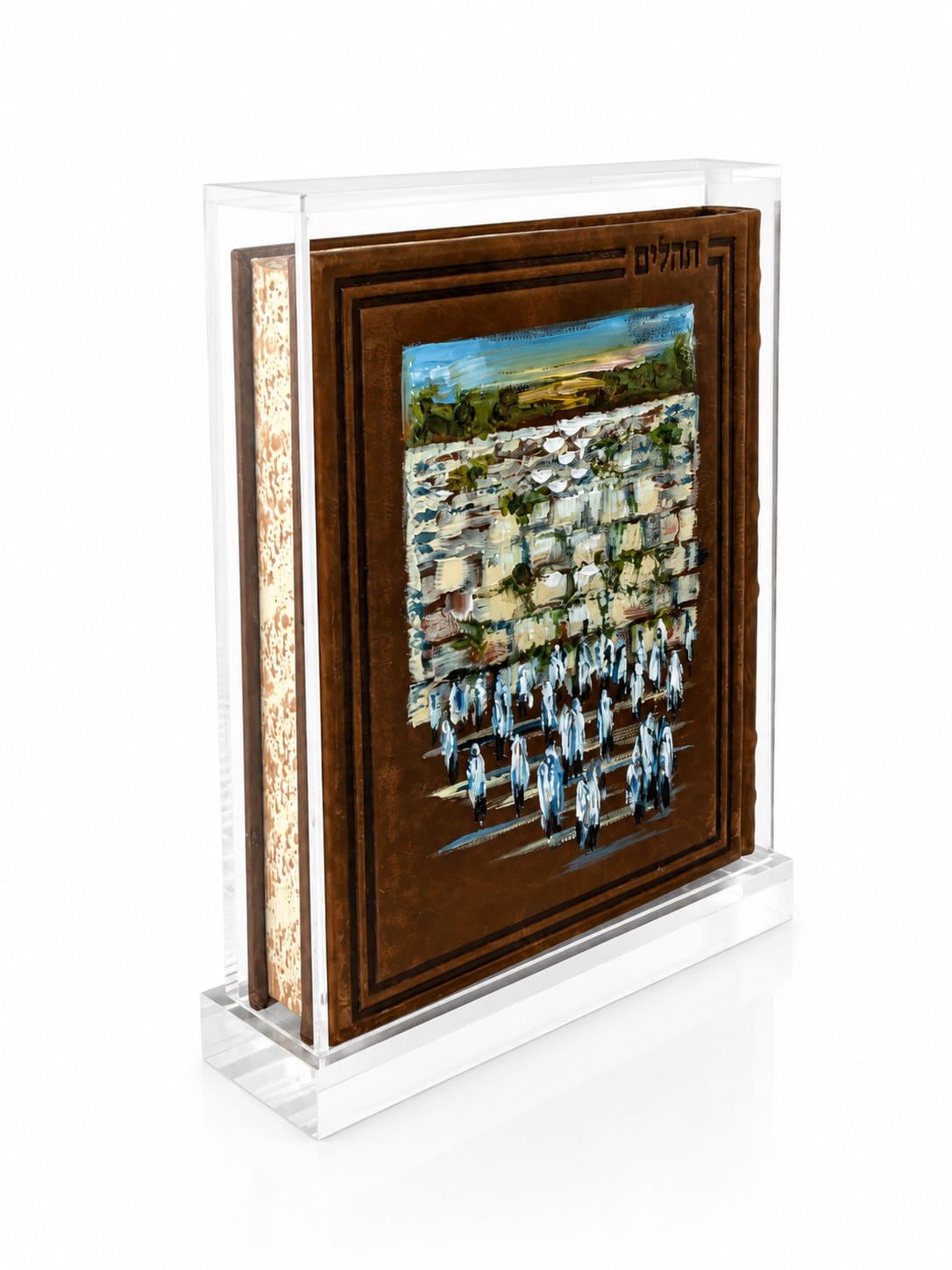 A brown leather tehillim featuring a painting of people praying at the Western Wall of Jerusalem, enclosed in a clear acrylic block on a white background - Zstander