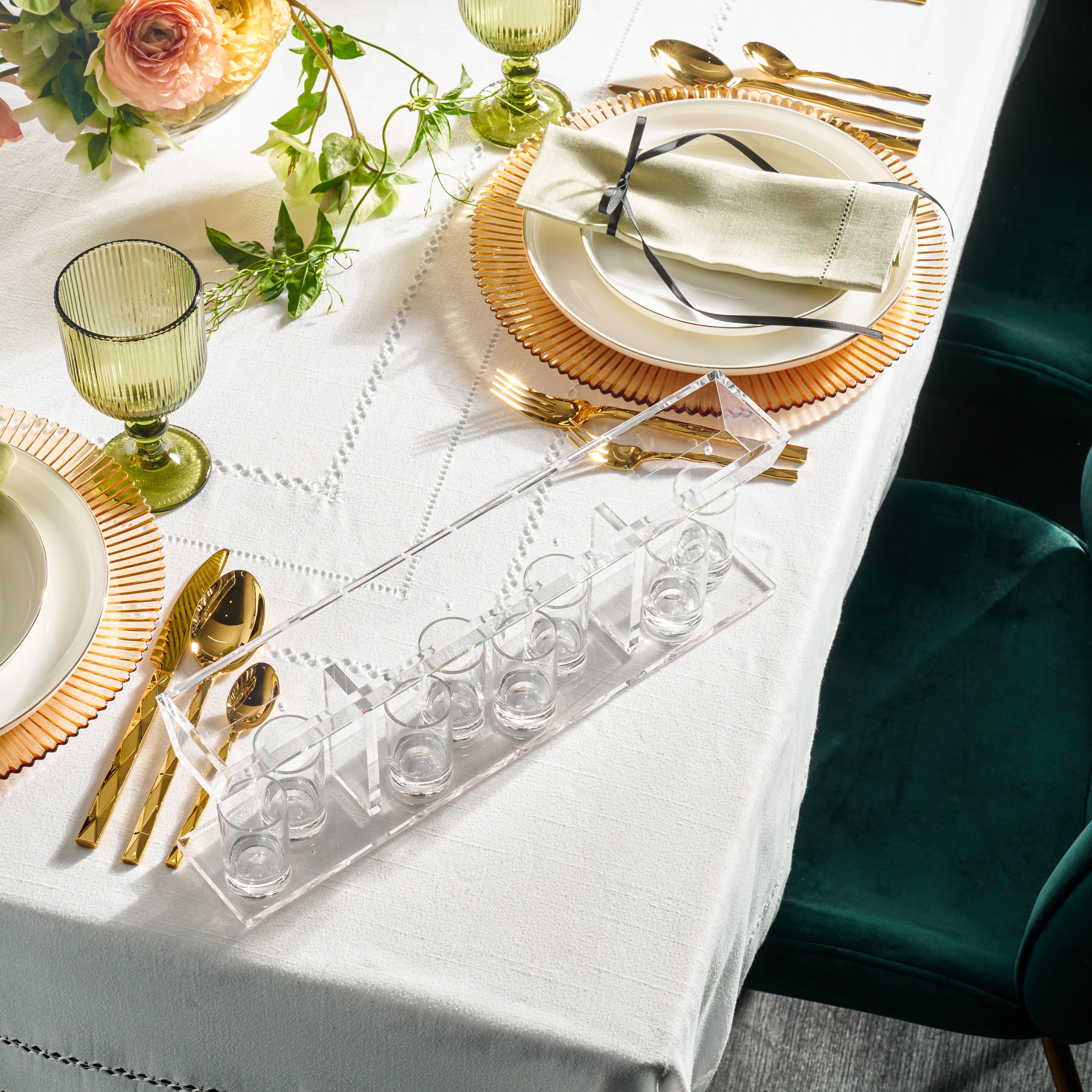 Clear lucite kiddush fountain on a table from a top view - Zstander