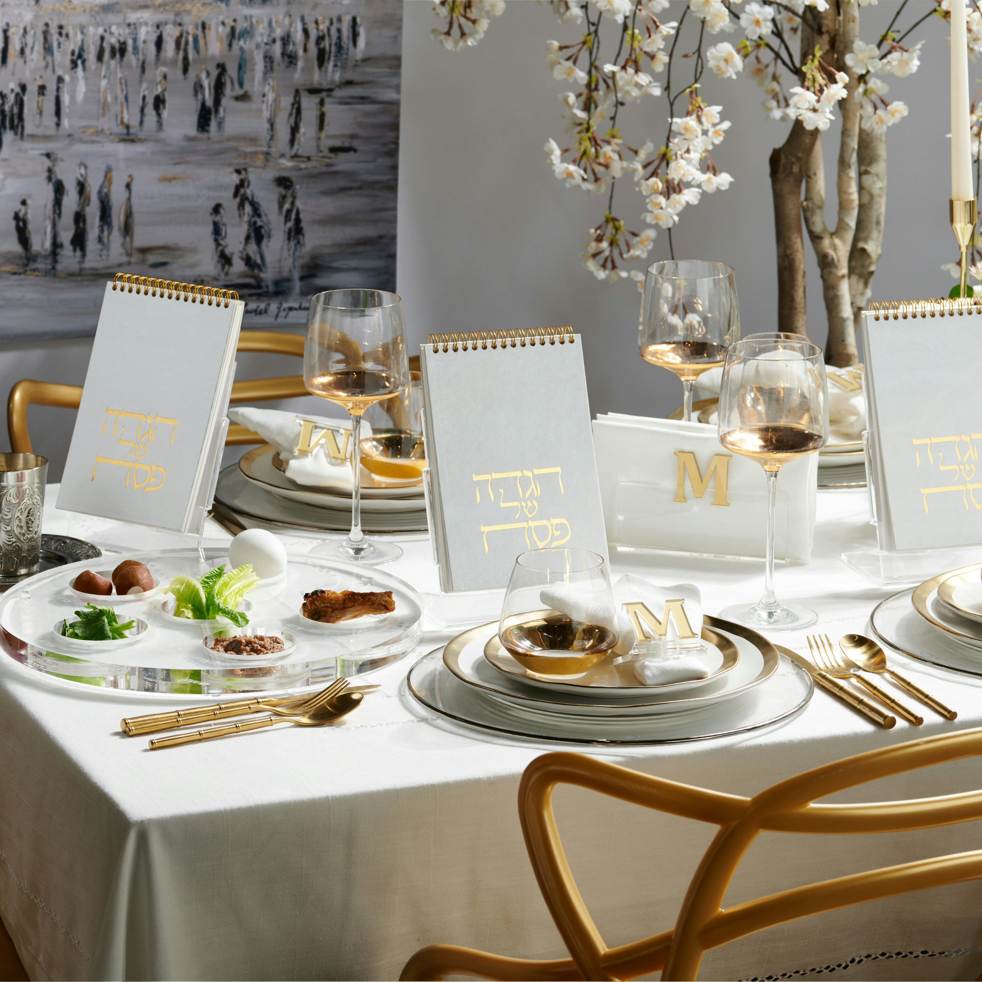 Full passover table set up with spiral haggadahs on a lucite stand - Zstander
