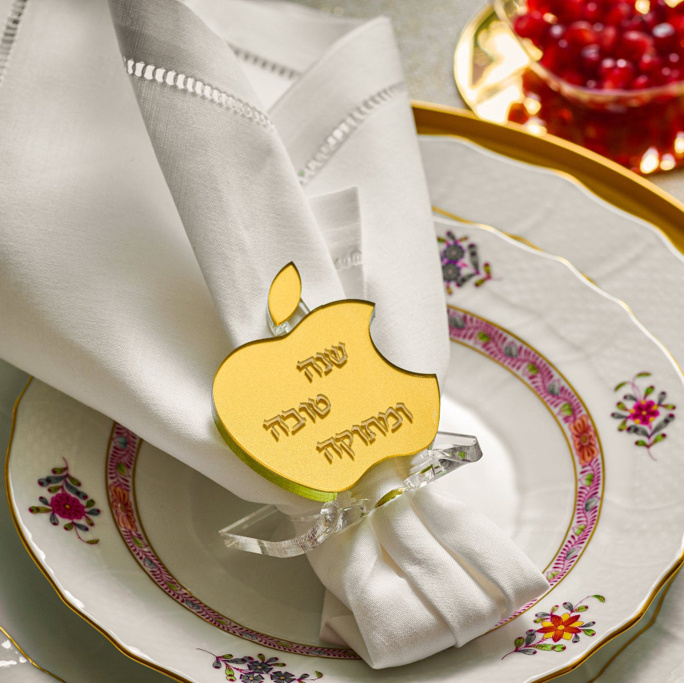 Decorative table setting with gold napkin ring, white napkin, and floral-patterned plates - Zstander
