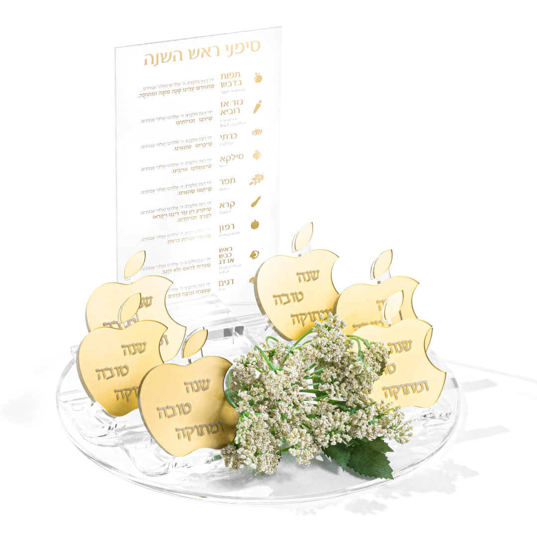 Decorative Rosh Hashana set with gold apple-shaped napkin rings and a bouquet of flowers on a white background - Zstander