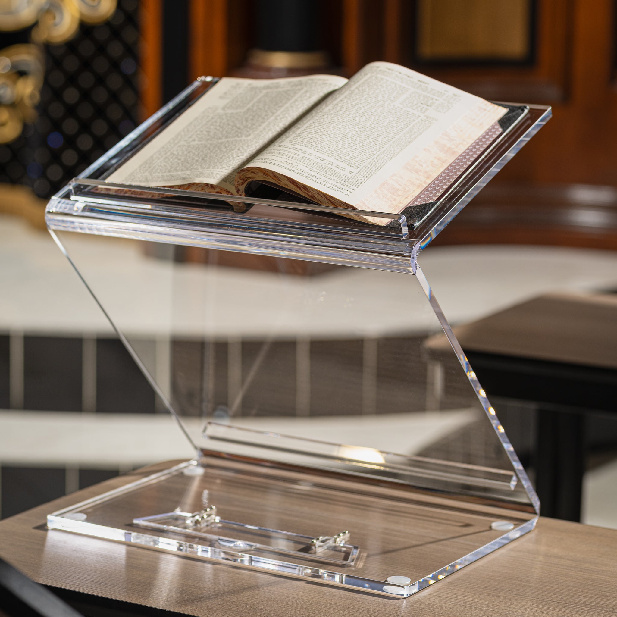 Clear acrylic book stand holding an open book on a wooden surface - Zstander