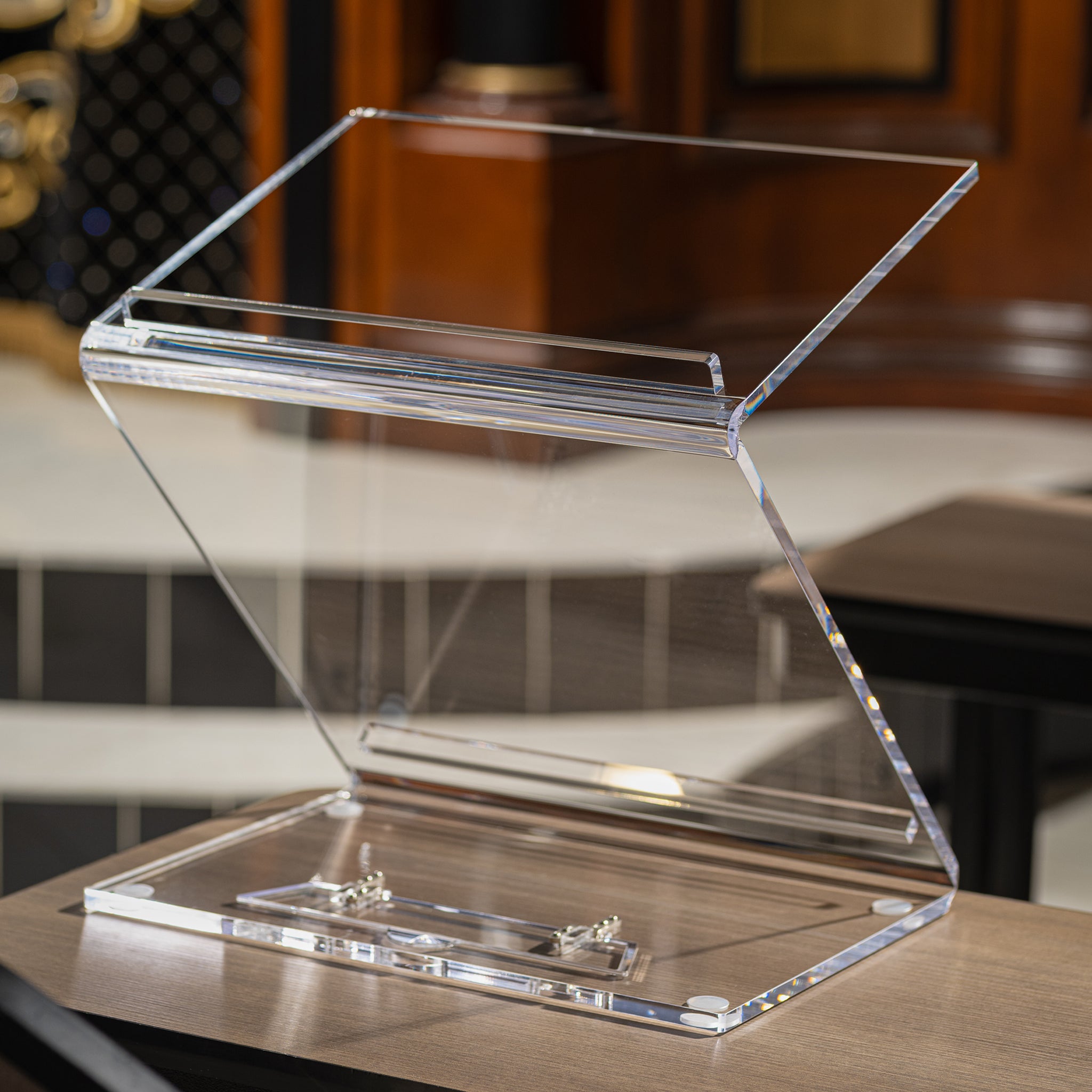 Clear acrylic Shtender on a wooden surface with a blurred background - Zstander