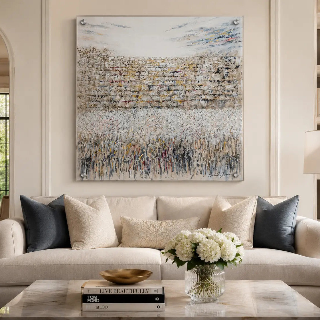 Living room with a beige sofa, coffee table, and abstract Birchas Kohanim painting on the wall - Zstander