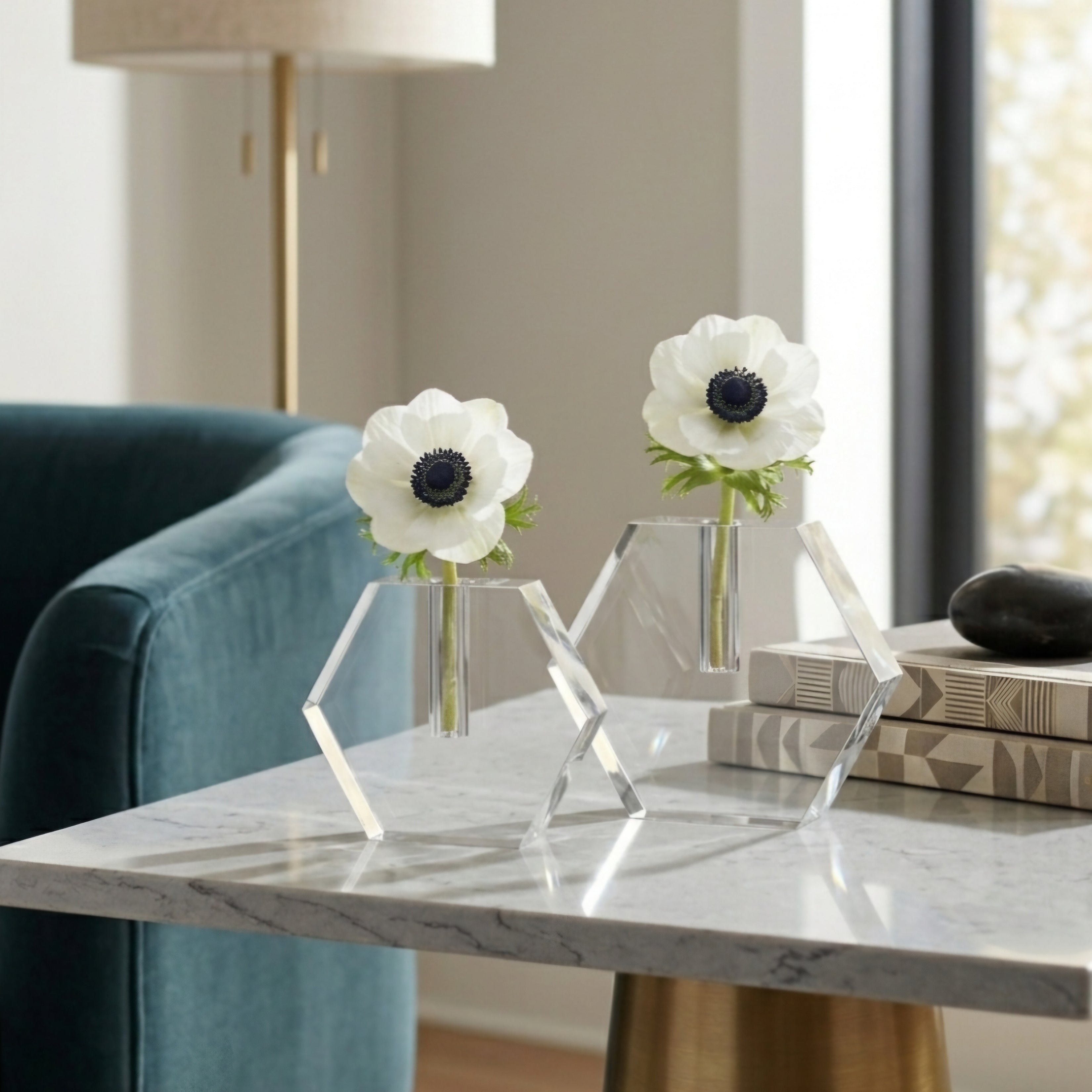 Decorative table with marble surface, two vases with white flowers, and books in a room - Zstander