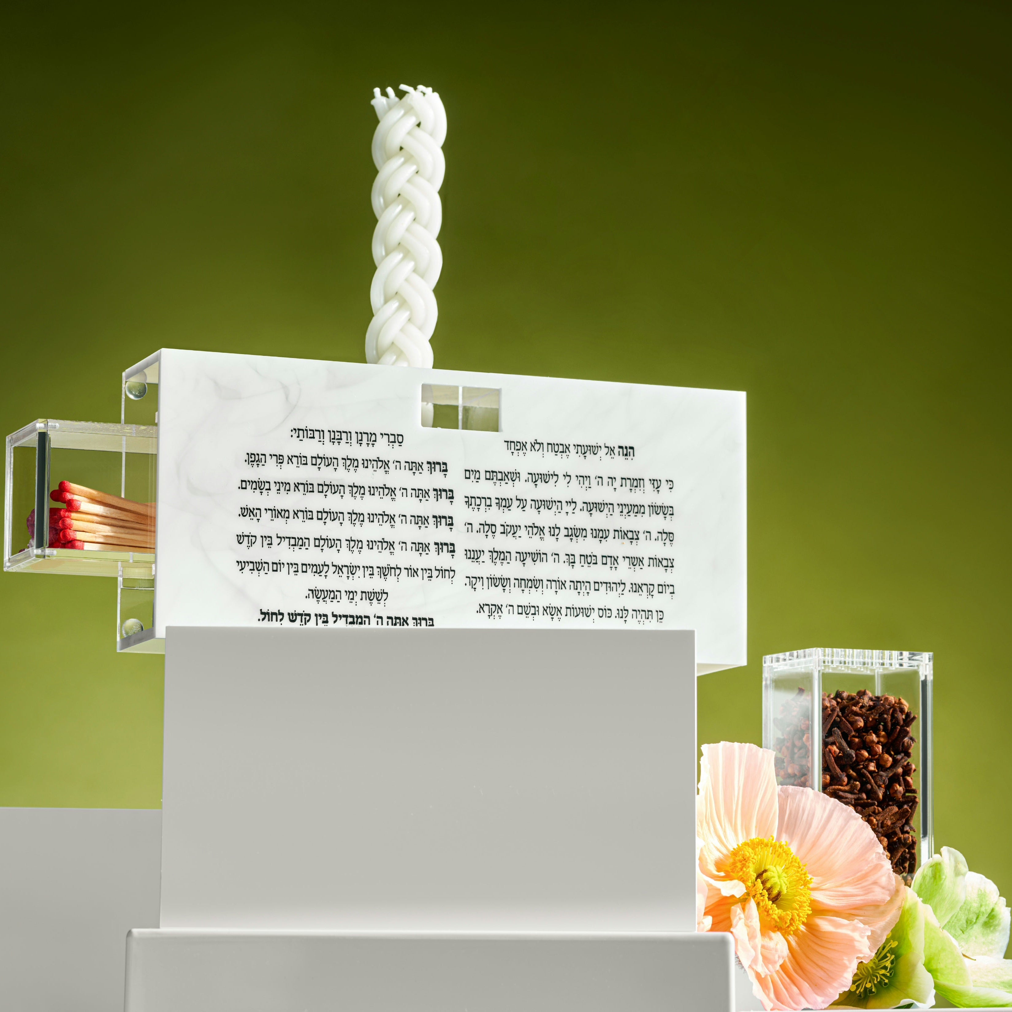 Zstander havdalah set with candle, matches and besamim on a green background