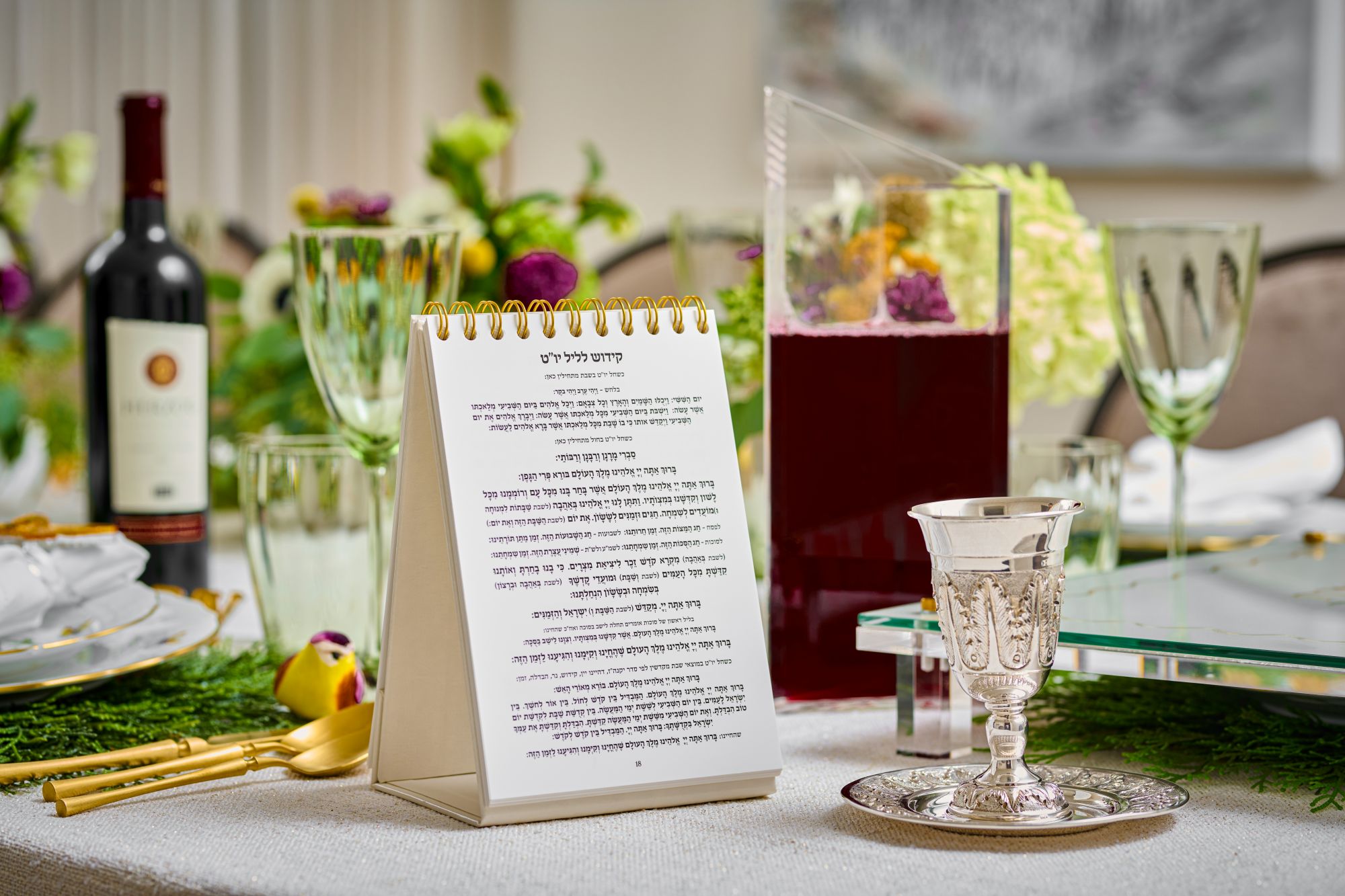 Table setting with a silver goblet, wine bottle, and floral decorations - Zstander