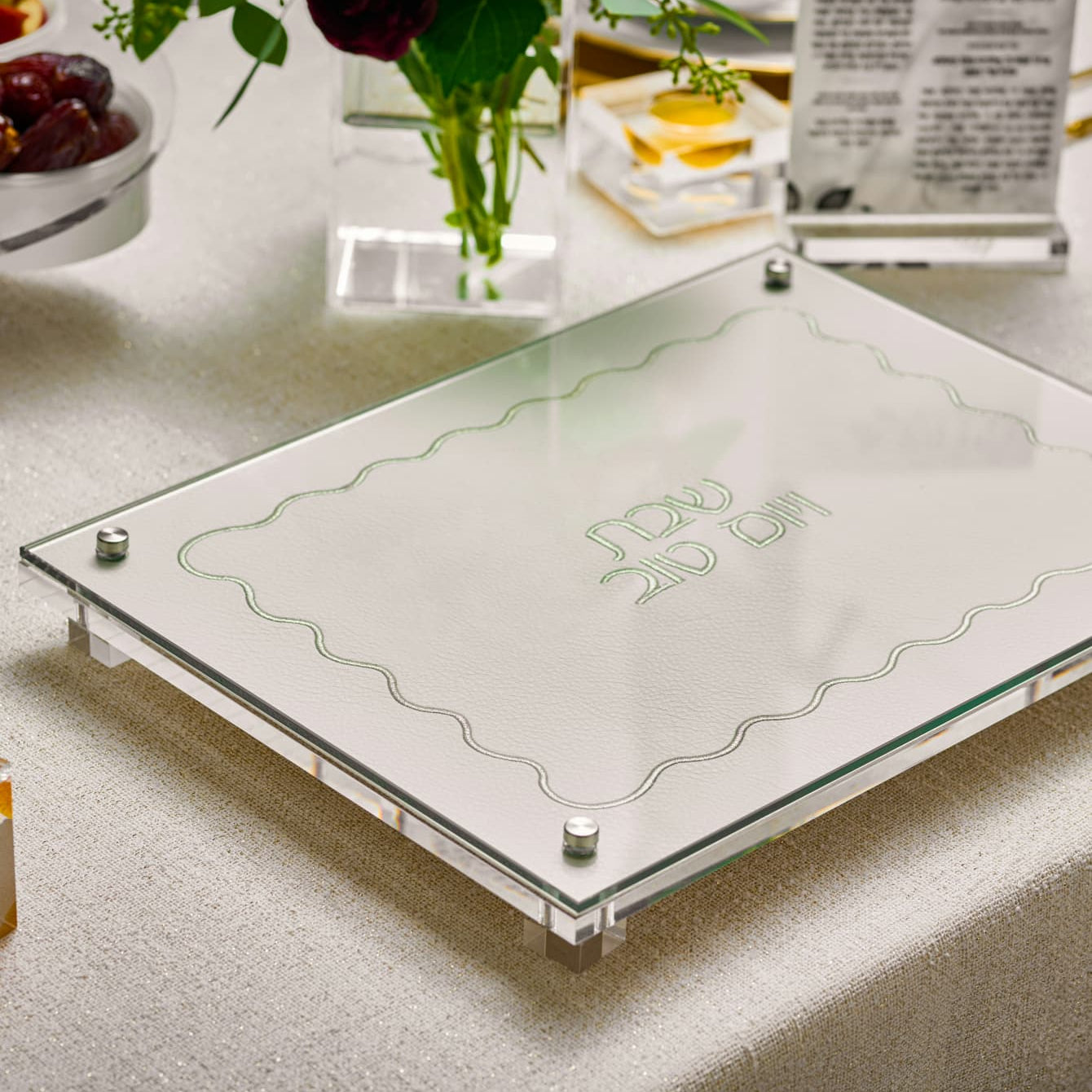 challah board with Hebrew text on a table setting - Zstander