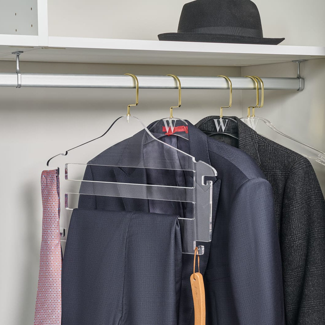 Clear hangers with clothes on a white shelf - Zstander
